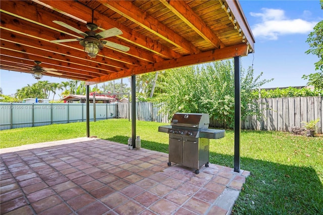 view of patio / terrace with area for grilling, a ceiling fan, and a fenced backyard