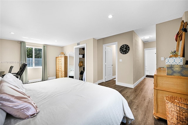 bedroom with recessed lighting, baseboards, visible vents, and wood finished floors