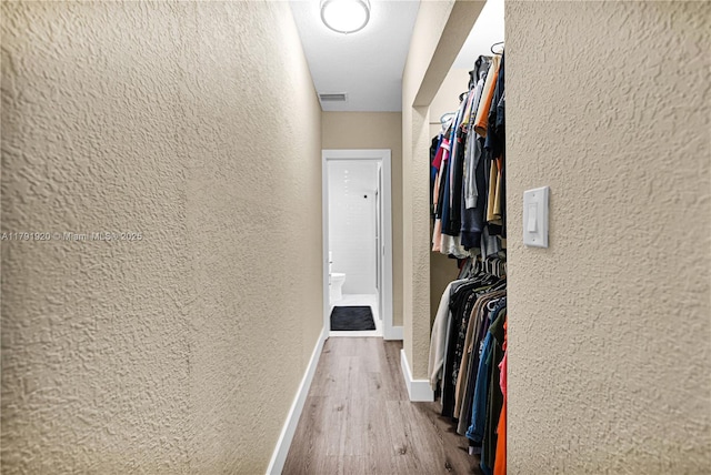 spacious closet with visible vents and wood finished floors