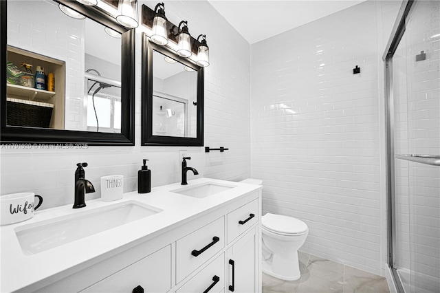 bathroom with a sink, a shower stall, and tile walls