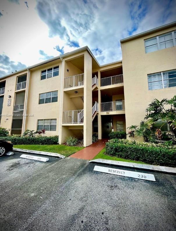 view of building exterior with uncovered parking