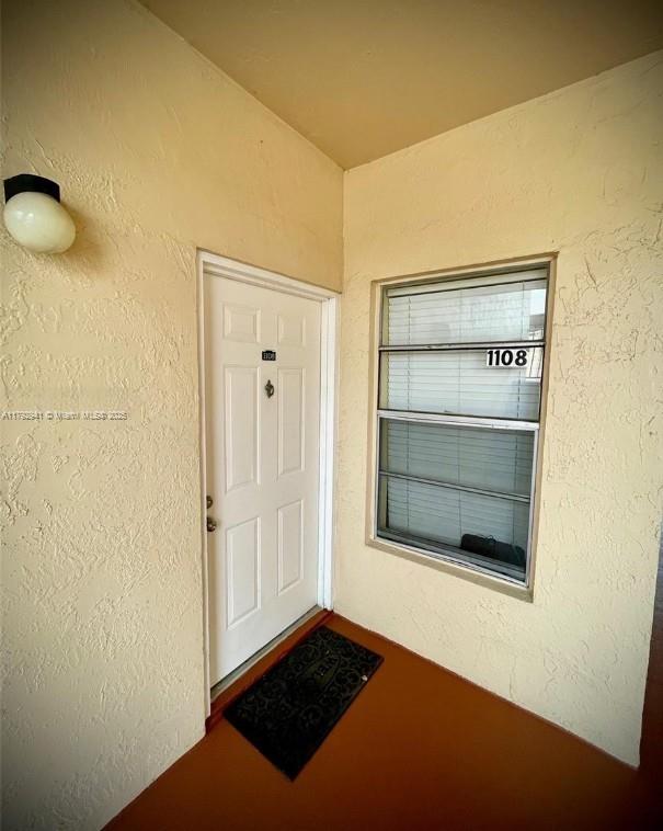 doorway to property with stucco siding