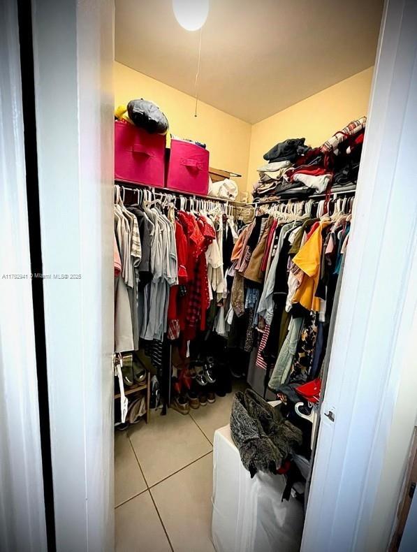 spacious closet with tile patterned flooring