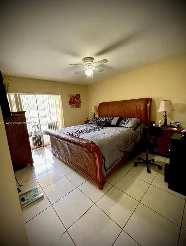 15320 SW 106th Ter Unit 1108, Miami, FL 33196 - bedroom with light tile patterned floors and a ceiling fan