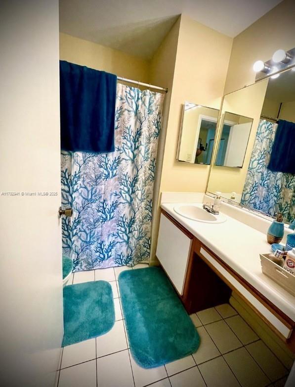 bathroom with vanity, tile patterned flooring, and a shower with shower curtain