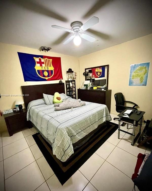 bedroom featuring light tile patterned flooring and a ceiling fan