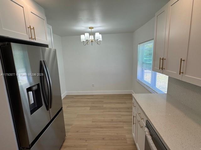 13333 SW 112th Pl, Miami, FL 33176 - kitchen featuring appliances with stainless steel finishes, a chandelier, and white cabinets