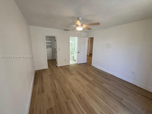 13333 SW 112th Pl, Miami, FL 33176 - unfurnished bedroom with baseboards, wood finished floors, a spacious closet, and a closet