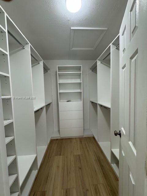 13333 SW 112th Pl, Miami, FL 33176 - spacious closet featuring wood finished floors and attic access