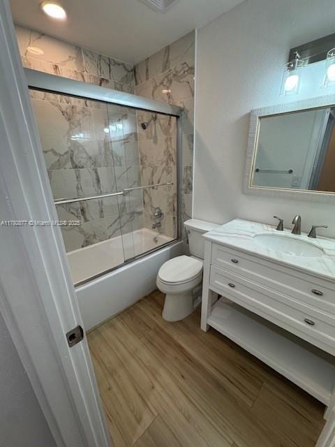 13333 SW 112th Pl, Miami, FL 33176 - full bathroom featuring vanity, combined bath / shower with glass door, wood finished floors, and toilet