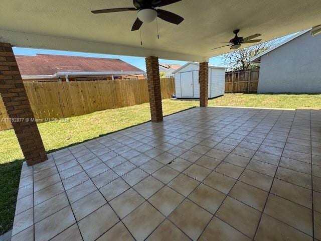 13333 SW 112th Pl, Miami, FL 33176 - view of patio / terrace with a fenced backyard, a ceiling fan, an outdoor structure, and a storage unit