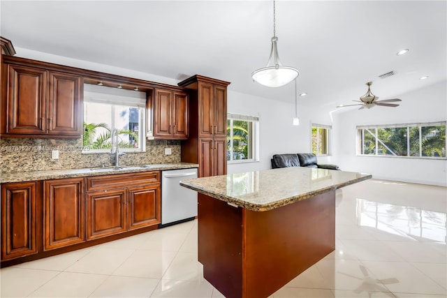 kitchen with plenty of natural light, decorative backsplash, and dishwasher