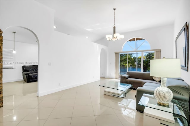 living room with arched walkways, light tile patterned floors, baseboards, a chandelier, and recessed lighting