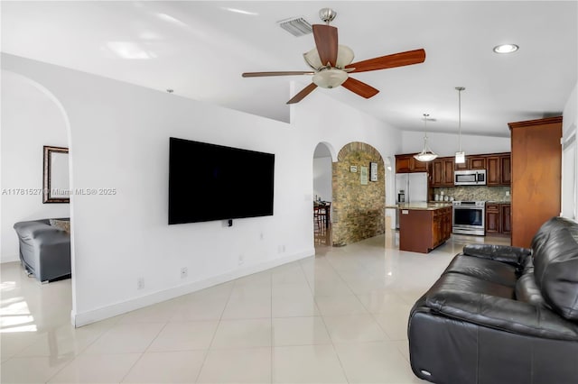 living room with ceiling fan, arched walkways, recessed lighting, baseboards, and visible vents