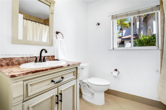 bathroom with tile patterned flooring, vanity, baseboards, toilet, and a shower with shower curtain