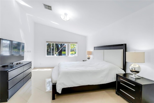 bedroom featuring lofted ceiling and visible vents