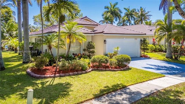 mediterranean / spanish house featuring a garage, a front lawn, stucco siding, a tiled roof, and concrete driveway