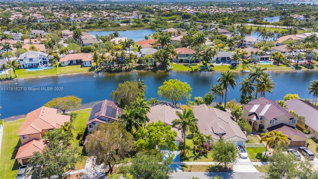 drone / aerial view featuring a water view and a residential view