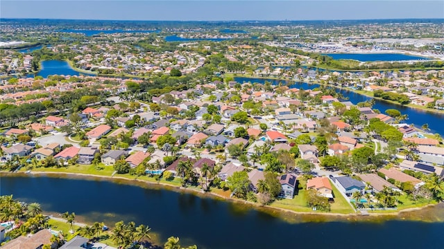 drone / aerial view with a water view and a residential view