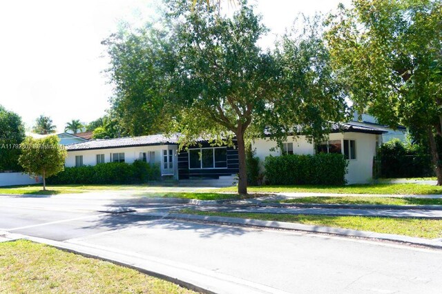 1955 SW 5th Ave, Miami, FL 33129 - ranch-style home featuring stucco siding and a front yard