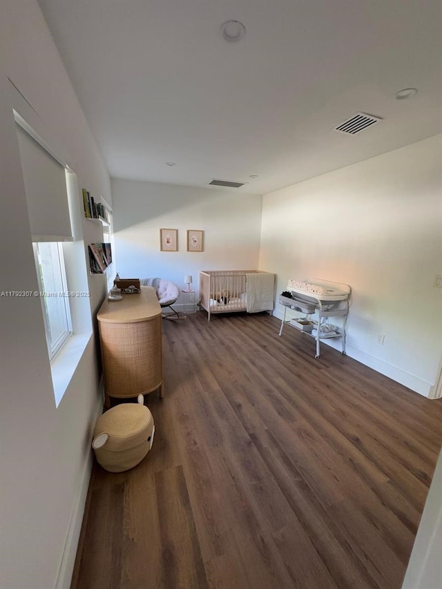 bedroom featuring baseboards, dark wood-style flooring, and visible vents