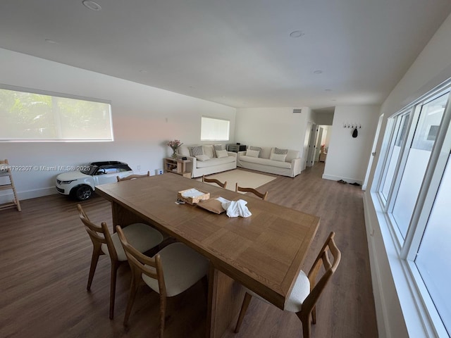 dining space featuring wood finished floors and baseboards