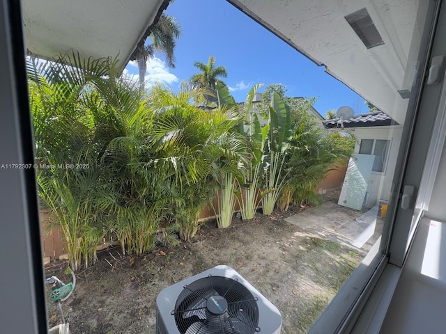 view of yard with central AC and fence private yard