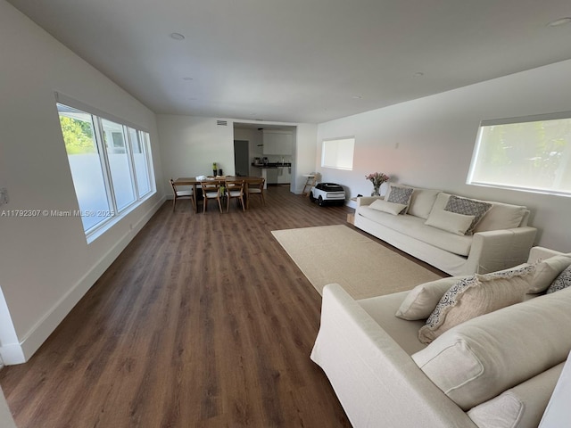 living room featuring dark wood finished floors and baseboards
