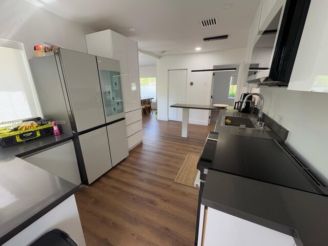1955 SW 5th Ave, Miami, FL 33129 - kitchen featuring freestanding refrigerator, white cabinets, dark wood-type flooring, dark countertops, and recessed lighting