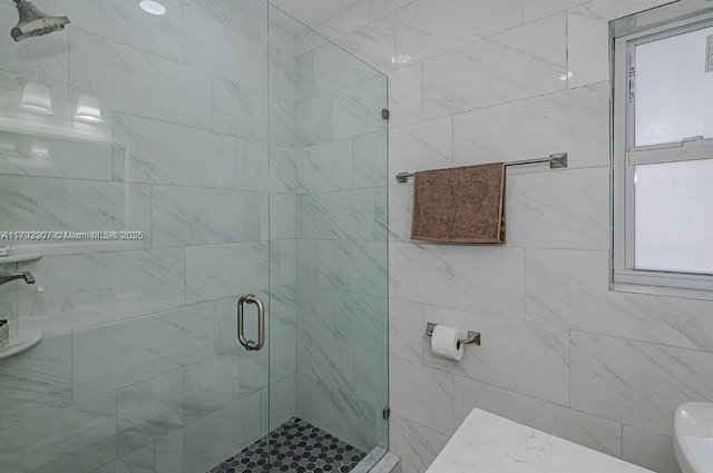 bathroom featuring a stall shower and toilet