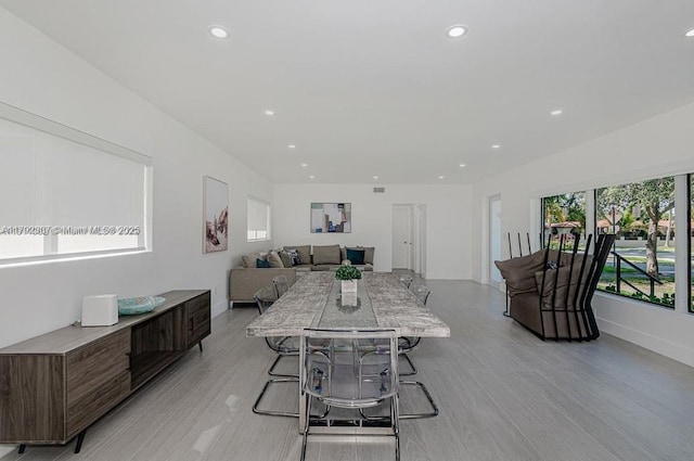 dining room with baseboards, light wood-style flooring, and recessed lighting