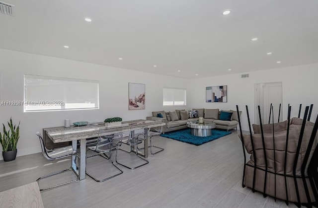 living area featuring visible vents, wood finished floors, baseboards, and recessed lighting
