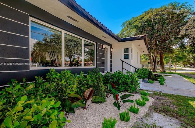 view of home's exterior featuring a tiled roof and stucco siding