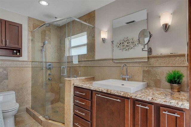 16840 SW 87th Ave, Palmetto Bay, FL 33157 - bathroom featuring tile walls, vanity, a shower stall, and wainscoting