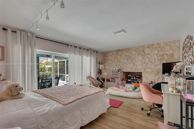 16840 SW 87th Ave, Palmetto Bay, FL 33157 - bedroom with access to exterior, wood finished floors, and track lighting