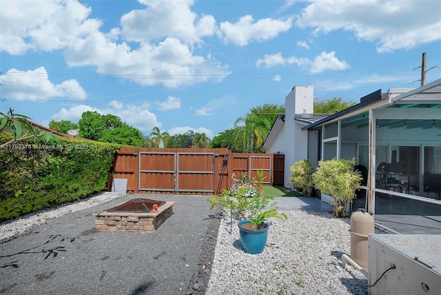 16840 SW 87th Ave, Palmetto Bay, FL 33157 - view of yard featuring a gate, an outdoor fire pit, and a patio area