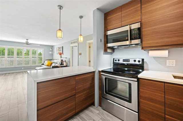 1770 E Las Olas Blvd Unit 507, Fort Lauderdale, FL 33301 - kitchen featuring stainless steel appliances, brown cabinets, and light countertops