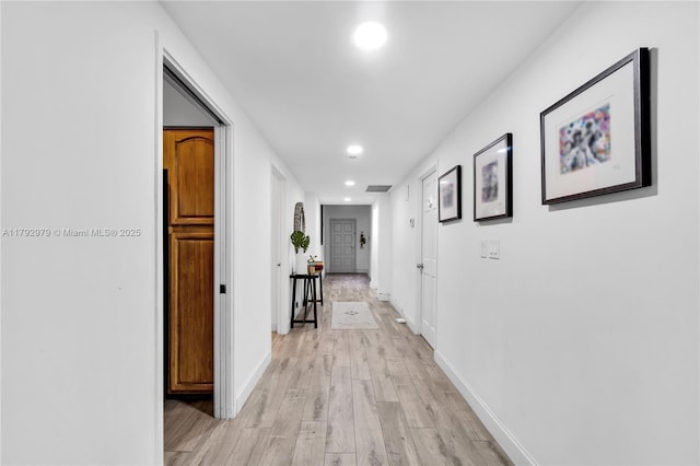 hall featuring recessed lighting, baseboards, visible vents, and light wood-style floors