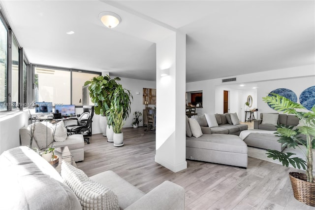 living area featuring wood finished floors and visible vents
