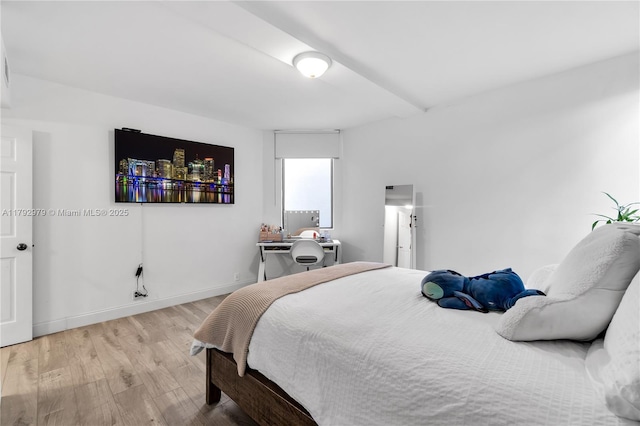 bedroom with baseboards and light wood-type flooring