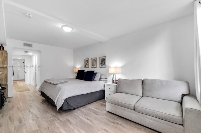 bedroom featuring visible vents and light wood finished floors