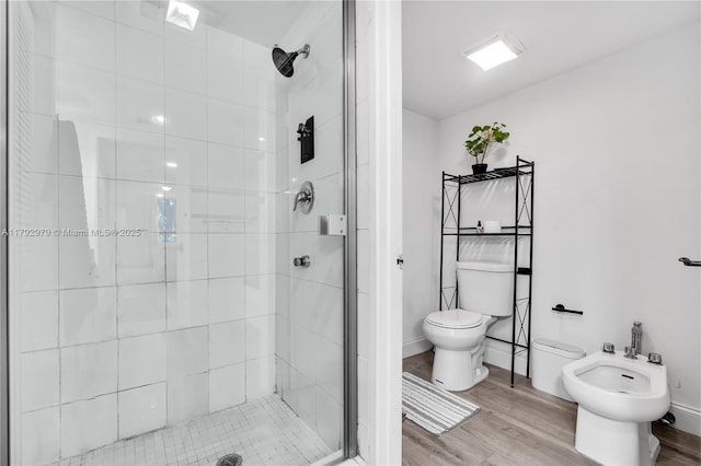 full bath featuring wood finished floors, a bidet, a stall shower, and toilet