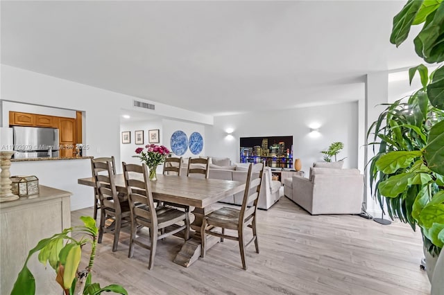 dining room featuring visible vents and light wood-type flooring