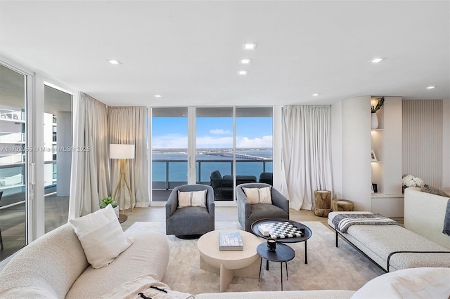 2127 Brickell Ave Unit 2704, Miami, FL 33129 - living room with a healthy amount of sunlight, a water view, expansive windows, and wood finished floors