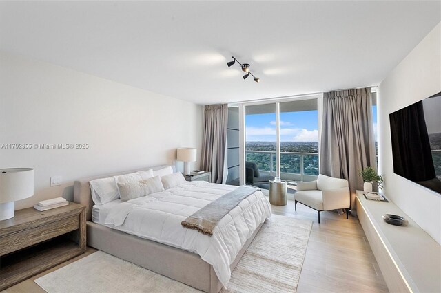 2127 Brickell Ave Unit 2704, Miami, FL 33129 - bedroom featuring wood finished floors and expansive windows