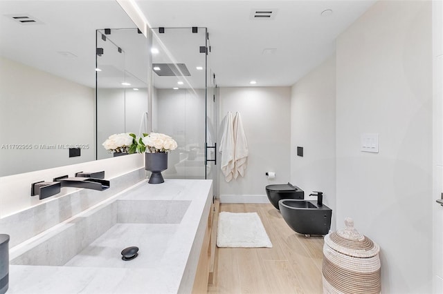 2127 Brickell Ave Unit 2704, Miami, FL 33129 - full bath featuring toilet, wood finished floors, visible vents, a bidet, and a stall shower