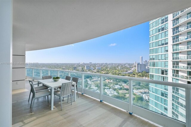 2127 Brickell Ave Unit 2704, Miami, FL 33129 - balcony featuring outdoor dining area and a city view