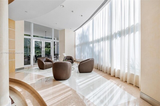 2127 Brickell Ave Unit 2704, Miami, FL 33129 - interior space with french doors, a towering ceiling, and a wall of windows