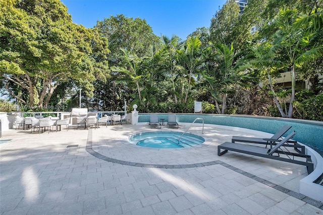 2127 Brickell Ave Unit 2704, Miami, FL 33129 - community pool featuring fence, a community hot tub, and a patio area