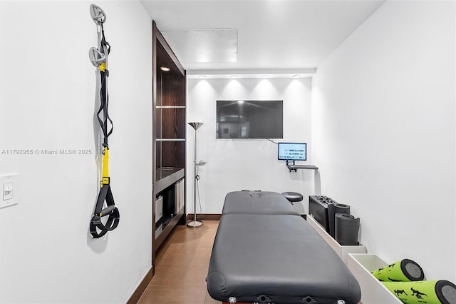 2127 Brickell Ave Unit 2704, Miami, FL 33129 - workout room with baseboards and wood finished floors